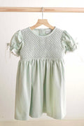 Sage green hand-smocked lace dress with puff sleeves, perfect for special occasions.