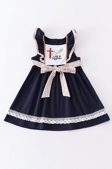 Navy dress with "He is Risen" embroidery, perfect for Easter celebrations.
