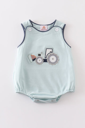 A playful green bubble romper featuring a cheerful excavator applique for boys.