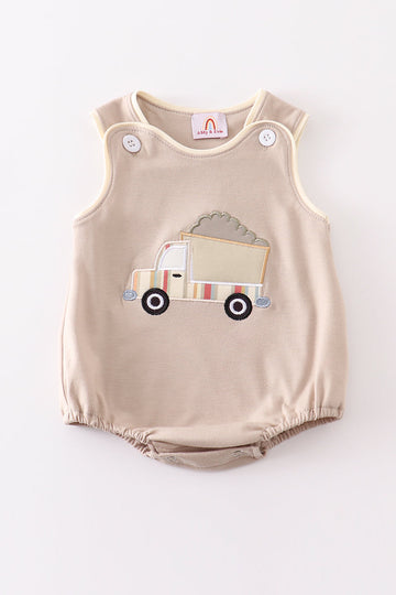 Khaki bubble romper with a cheerful truck applique, perfect for playtime.