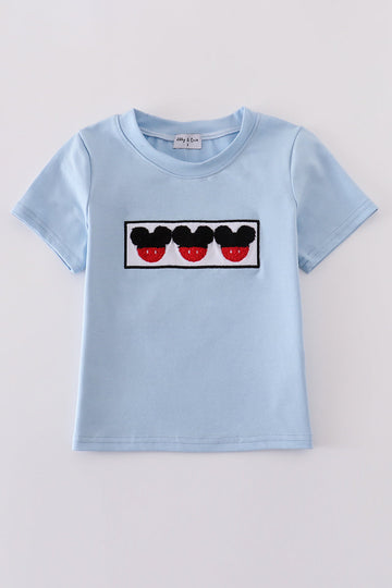 Blue character French knot top with playful embroidered design, perfect for kids.