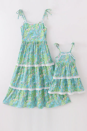 A charming green tiered dress with a floral pattern, perfect for matching mom and daughter.