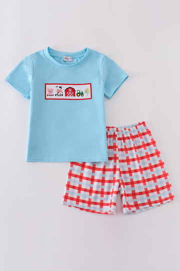 Children's blue smocked shorts set with charming farm animal embroidery.
