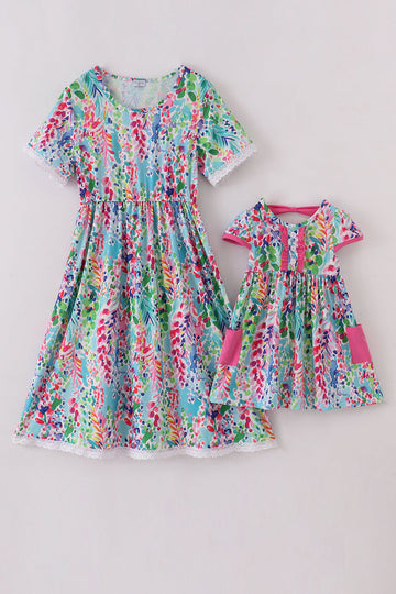 A vibrant Rainbow Garden print mom-and-me dress with playful floral patterns.