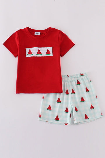 A charming red smocked set with playful watermelon embroidery, perfect for summer fun.