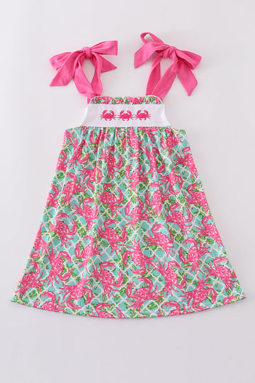 A charming pink dress with playful crab embroidery, perfect for summer fun.