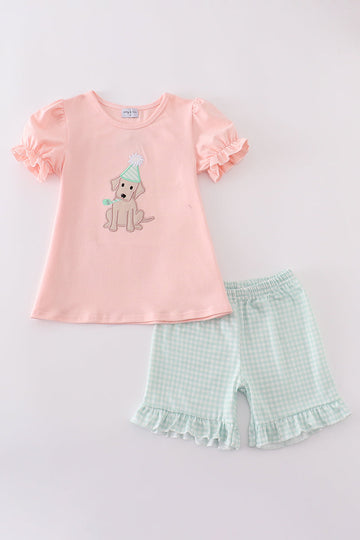 Pink puppy birthday outfit with cute applique on a soft, comfortable fabric.