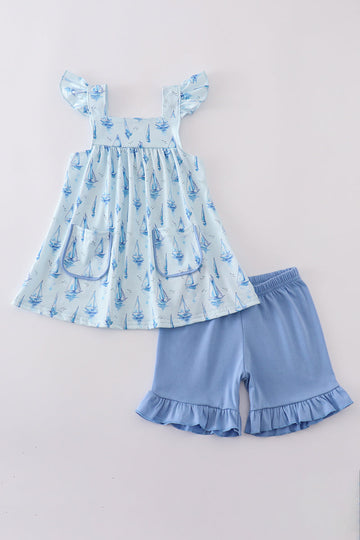 Blue sailboat print girl set featuring a playful nautical design, perfect for summer.