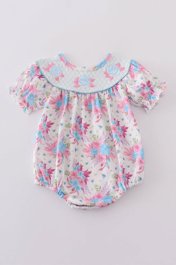 Whimsical blue bubble romper with floral embroidery, perfect for playful adventures.