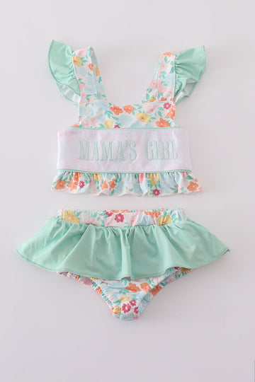 Green two-piece swimsuit with "MAMA'S GIRL" embroidery and floral pattern, perfect for spring.