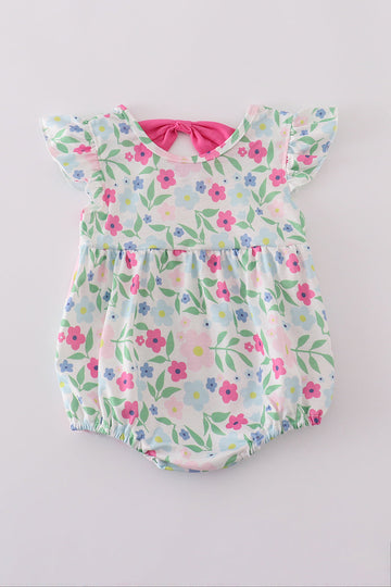 Adorable girl bubble romper with vibrant meadow print, perfect for playful adventures.