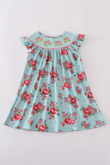 Smocked girl dress with rosebud print, perfect for a spring celebration.
