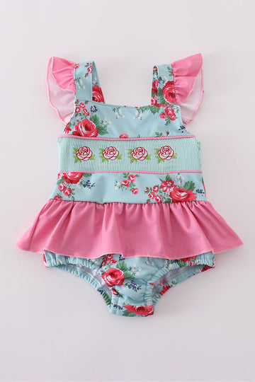 Colorful floral-print one-piece swimsuit with smocked details for girls.