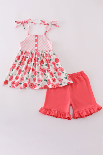 Pink floral print girl set featuring a ruffled top and matching shorts.