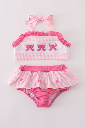 Pink stripe swimsuit with bow embroidery, perfect for a sunny beach day.