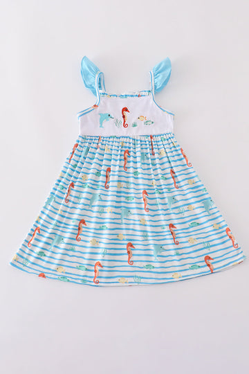 Blue dress with playful marine creature embroidery, perfect for seaside adventures.