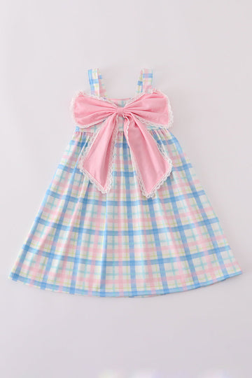 A charming pink plaid bow dress, perfect for playful adventures and special occasions.