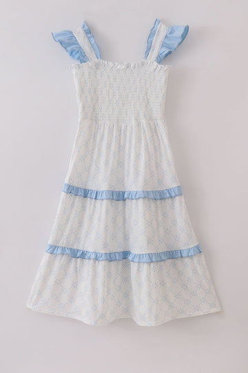 Blue tiered dress with classic lattice pattern, perfect for special occasions.
