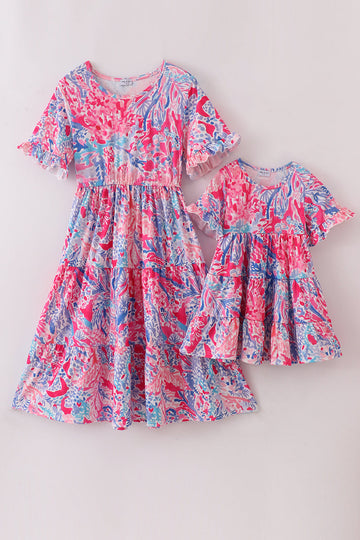Matching Pink Paradise Reef print mom&me dresses with vibrant coral and ocean patterns.