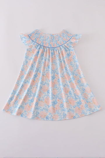 A charming blue smocked dress with floral ruffles, perfect for special occasions.