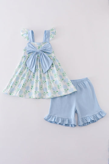 Adorable blue hydrangea print ruffle shorts set with a charming bow accent.