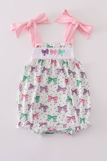 A sweet pink bubble romper with embroidered bow print, perfect for playtime.
