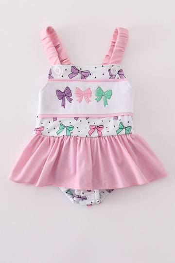 Pink swimsuit with bow embroidery, perfect for sunny beach days, UPF50+.
