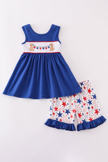 Adorable blue ruffle shorts set with puppy and star embroidery, perfect for playtime.