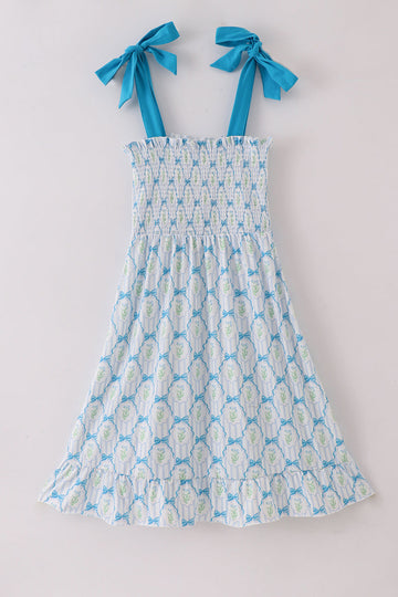 A charming blue floral mom dress with bow tie straps, perfect for spring.