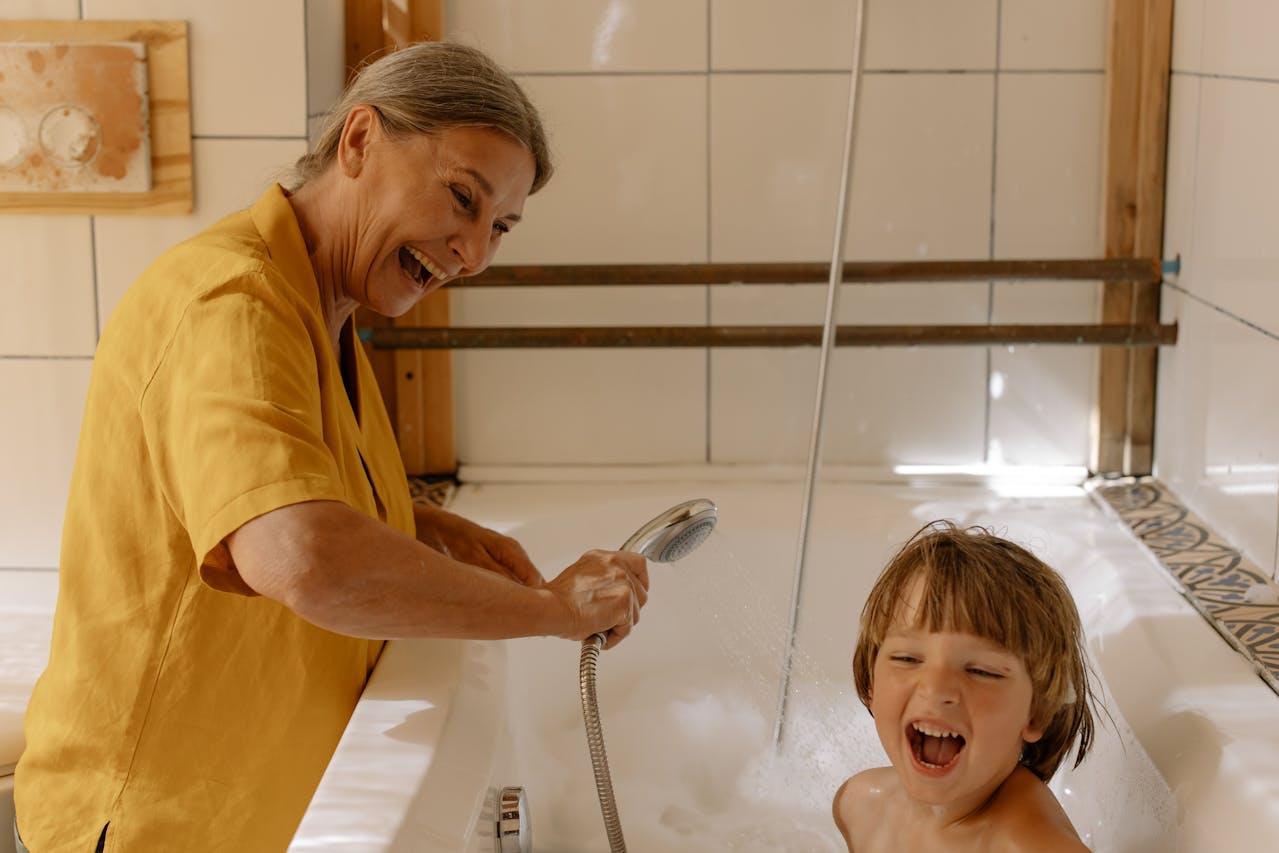 kid and parent having fun in bath