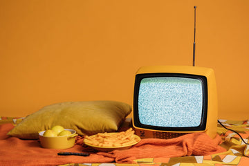 Blank Television screen with food sitting In front of it.
