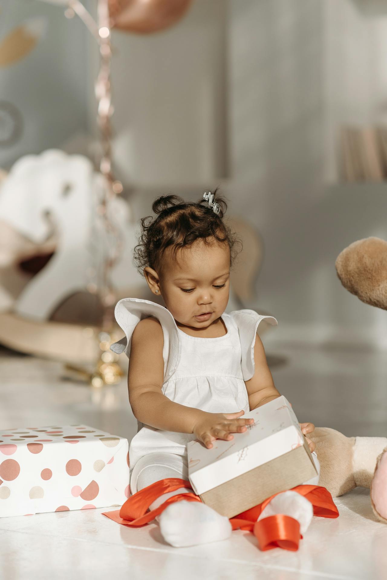 Child unwrapping gift wraps