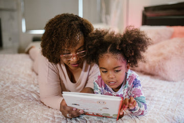 Mother and Daughter reading a story book together