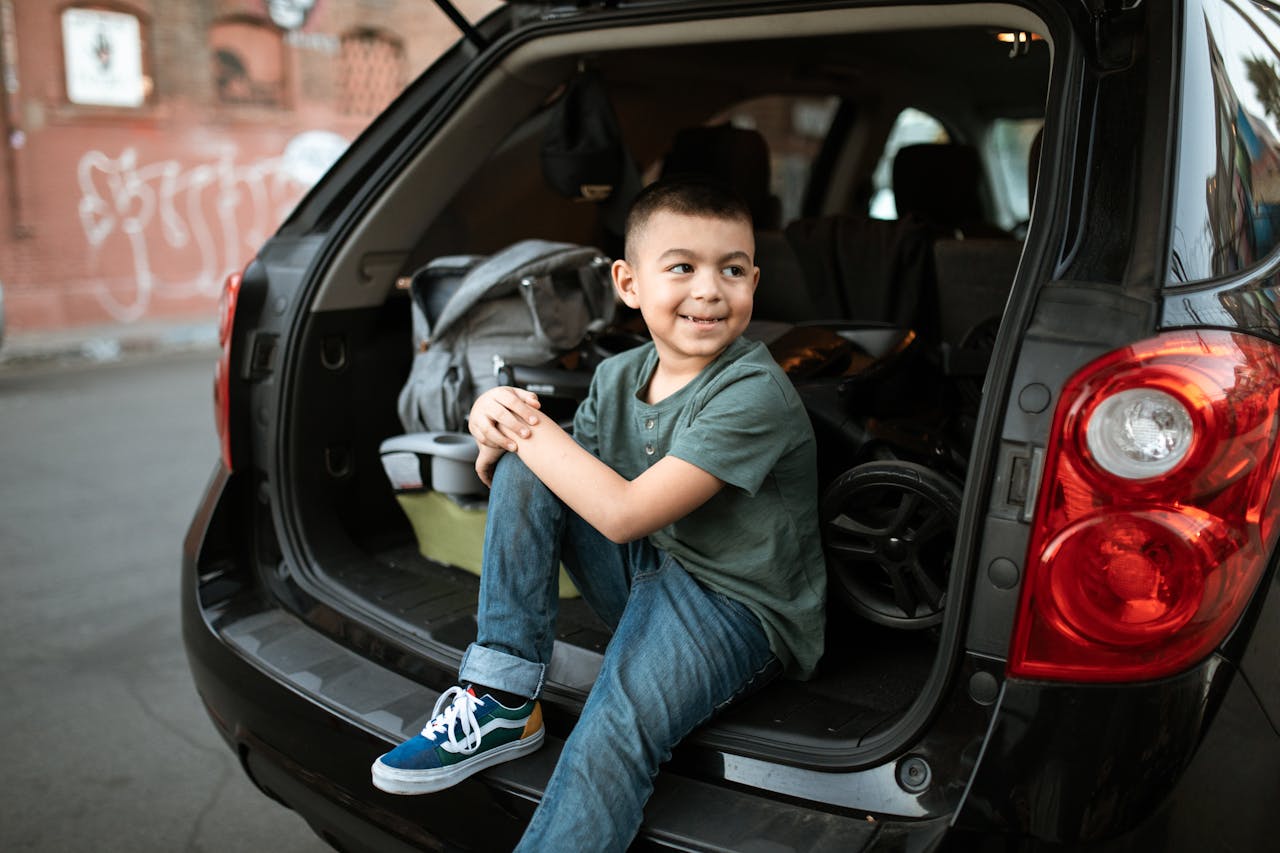Photo by RDNE Stock project: https://wwwa boy sitting in a car looking over his shoulder