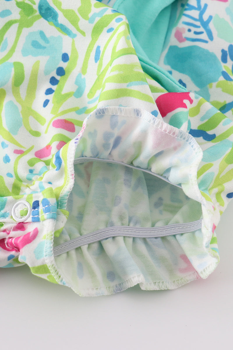 Tropical breeze print bubble romper with vibrant palm leaves, perfect for summer fun.