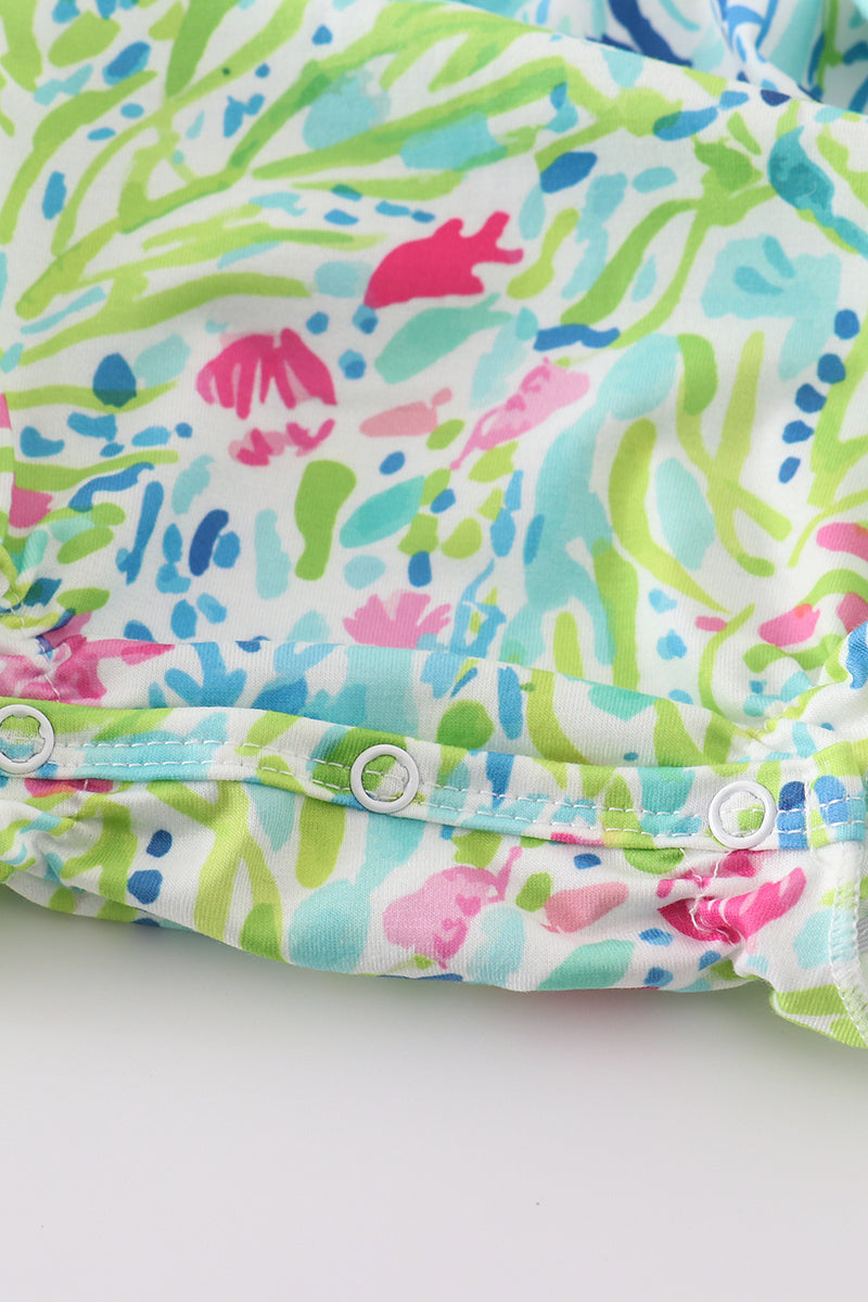 Tropical breeze print bubble romper with vibrant palm leaves, perfect for summer fun.