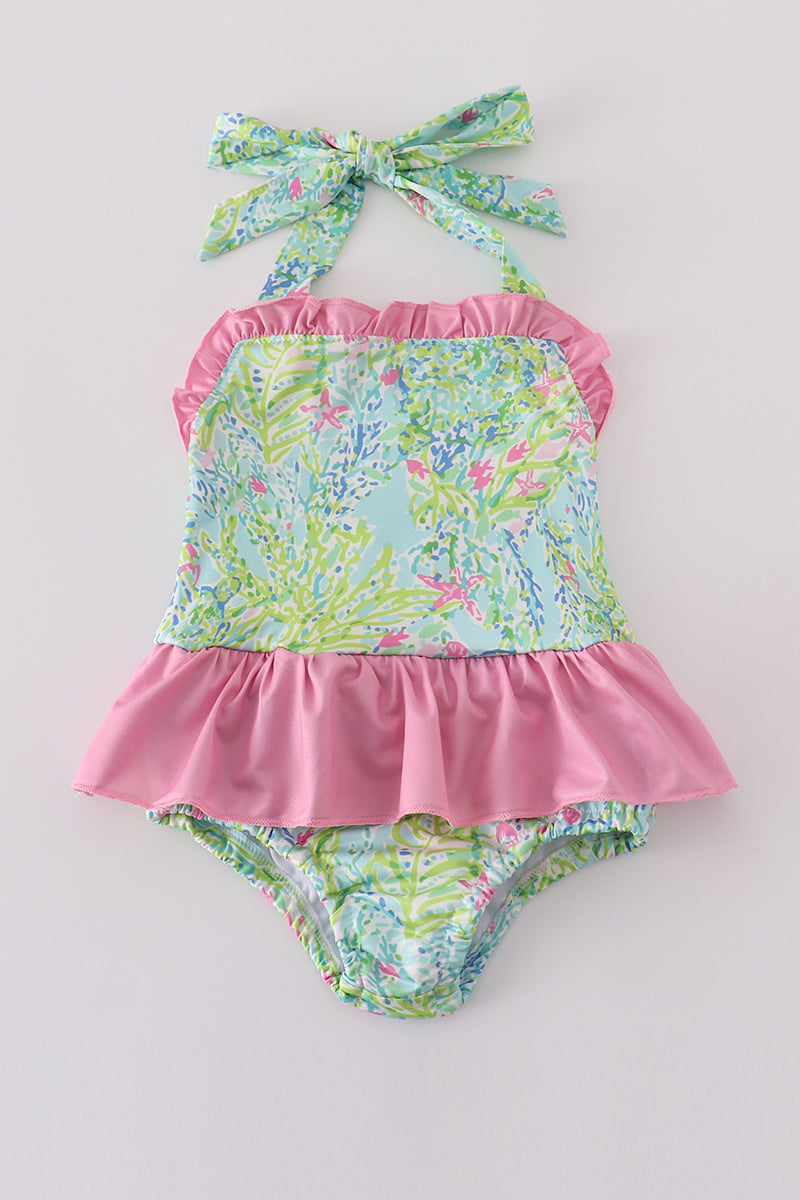 A vibrant, floral one-piece swimsuit for girls, perfect for sunny beach days.