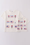 Children's top with flag bow, ice-cream, and sequin details, perfect for matching outfits.