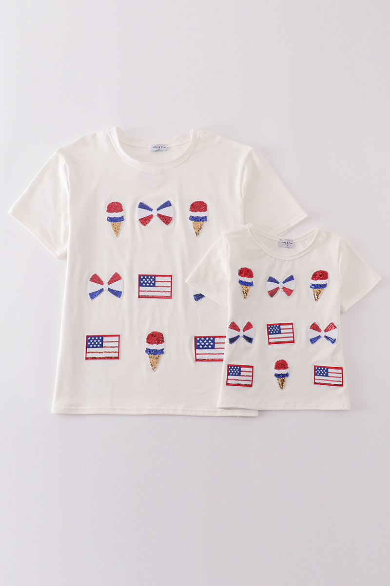 Children's top with flag bow, ice-cream, and sequin details, perfect for matching outfits.