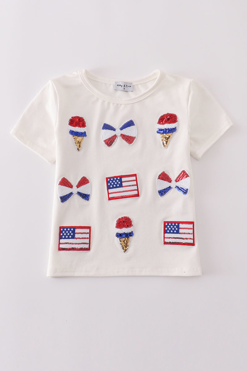 Children's top with flag bow, ice-cream, and sequin details, perfect for matching outfits.
