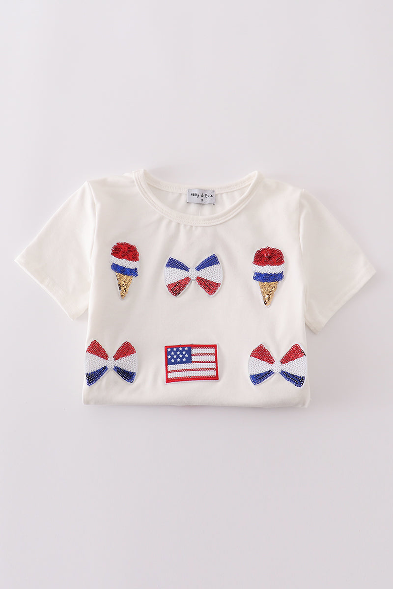 Children's top with flag bow, ice-cream, and sequin details, perfect for matching outfits.