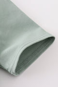 Sage green boy's shirt with delicate sand dollar embroidery, perfect for beach outings.