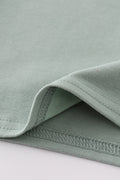 Sage green boy's shirt with delicate sand dollar embroidery, perfect for beach outings.
