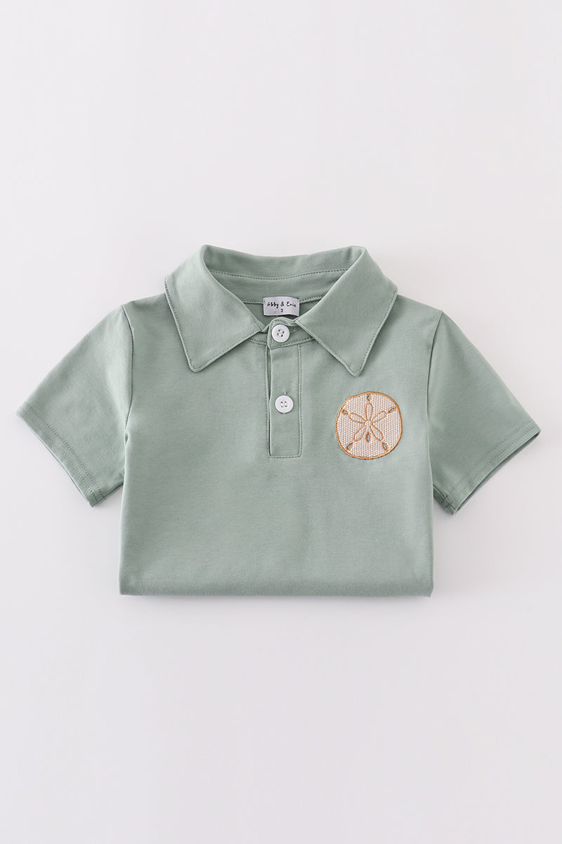 Sage green boy's shirt with delicate sand dollar embroidery, perfect for beach outings.