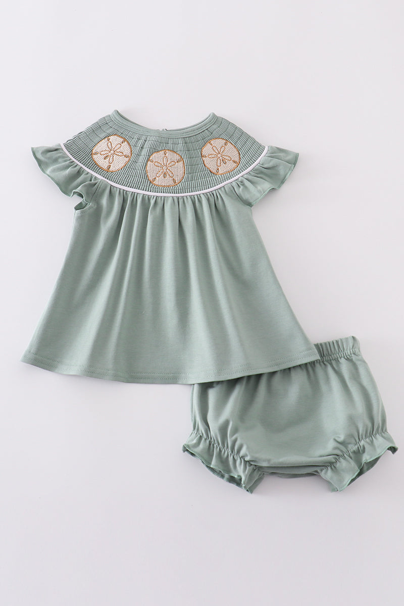 Sage green smocked bloomer set with sand dollar embroidery, perfect for summer.