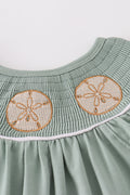 Sage green smocked bloomer set with sand dollar embroidery, perfect for summer.