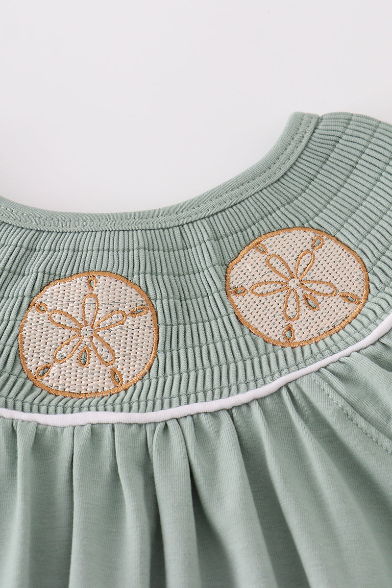 Sage green smocked bloomer set with sand dollar embroidery, perfect for summer.
