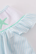 A charming blue stripe dress with starfish embroidery and smocked detailing, perfect for summer.