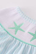 A charming blue stripe dress with starfish embroidery and smocked detailing, perfect for summer.