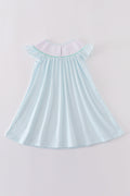 A charming blue stripe dress with starfish embroidery and smocked detailing, perfect for summer.